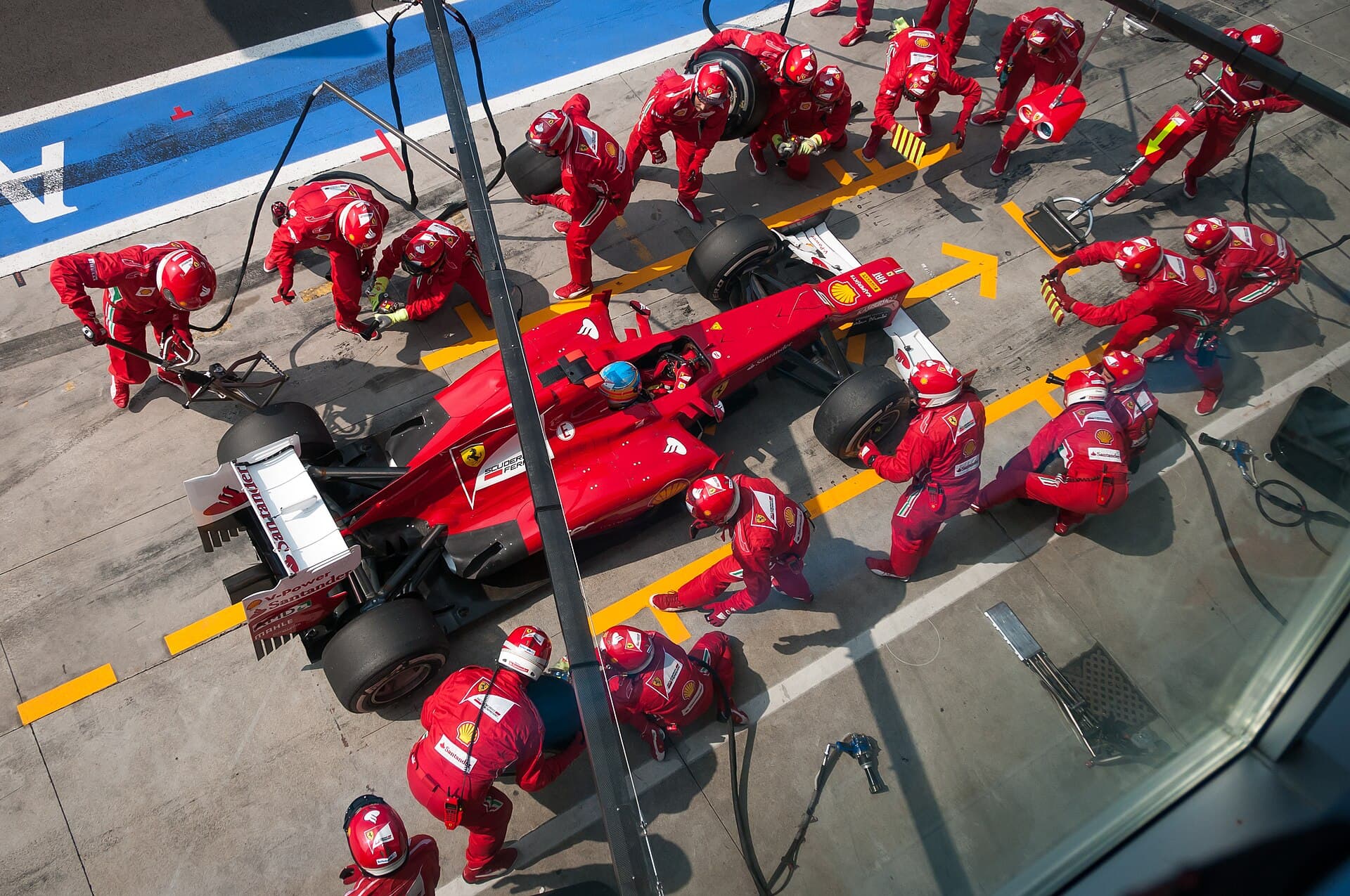 Ferrari's pit crew surrounding Fernando Alonso's car during a pit stop at the 2012 Italian Grand Prix